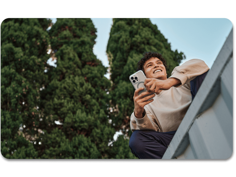 man holding an iphone 16 with a clear stylish case